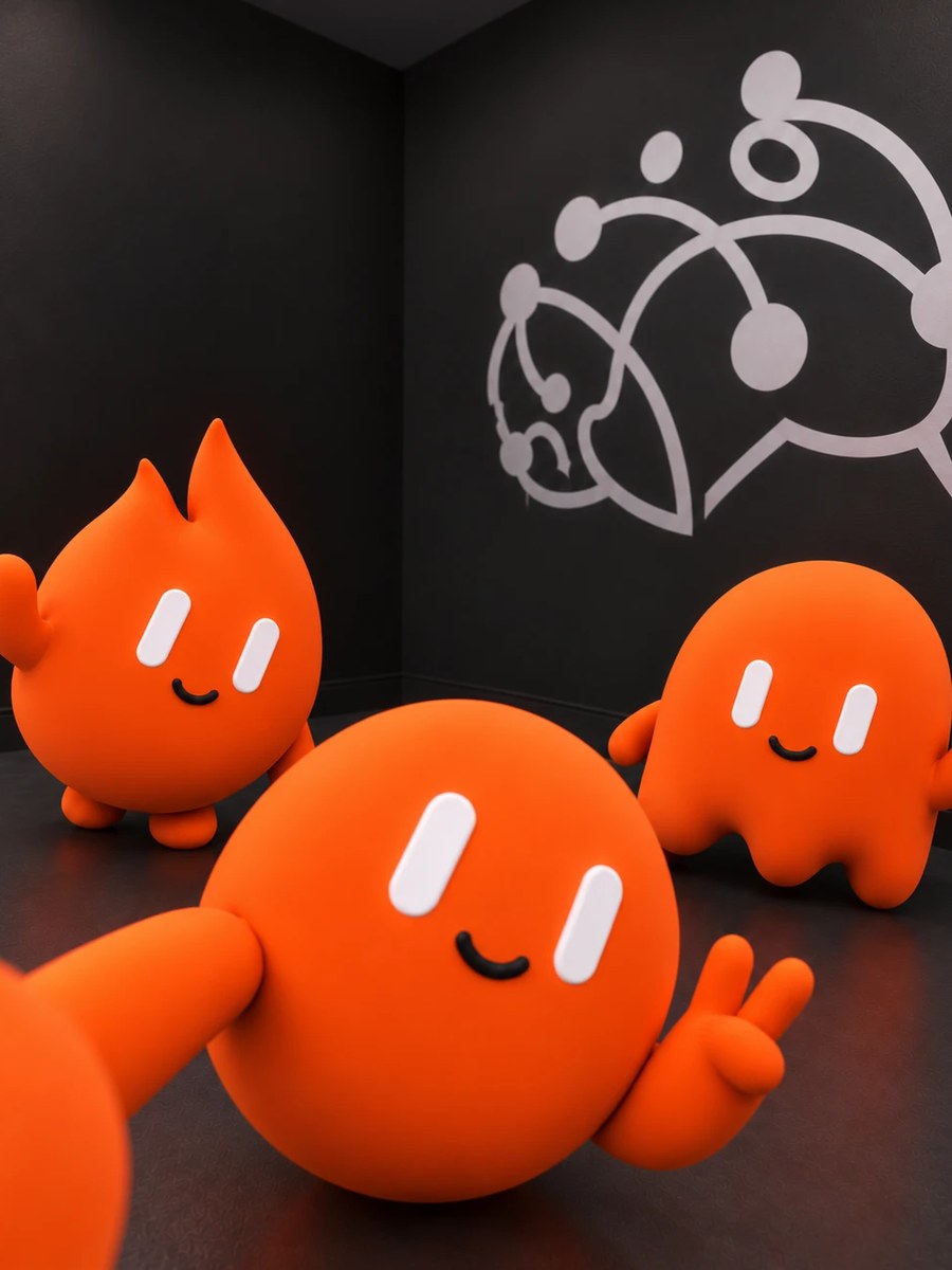 Wick and two other orange WickedlySmart mascots taking a selfie in front of the logo wall
